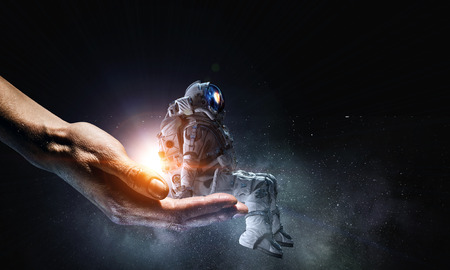 Spaceman in male hand. Mixed mediaの写真素材