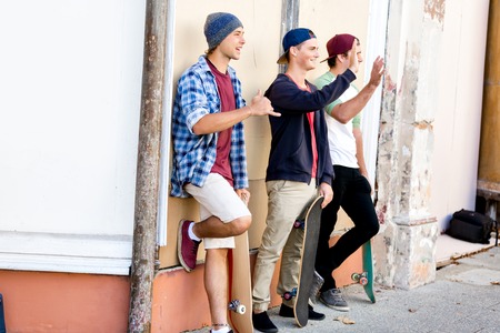 Teenage friends standing at the streetの写真素材