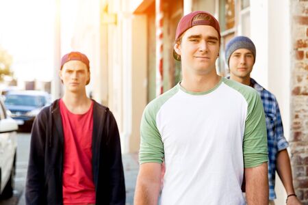 Teenage friends walking at the streetの写真素材