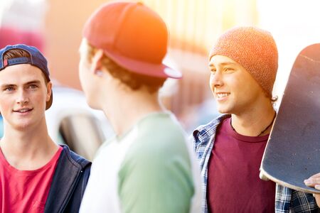 Teenagers walking down the street in summer day