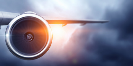 Wing and jet engine of airplane over sky. Mixed mediaの写真素材