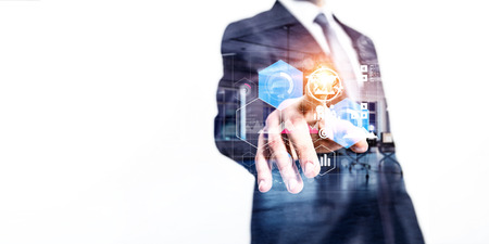 Close up of businessman touching screen with infographs. Mixed mediaの写真素材