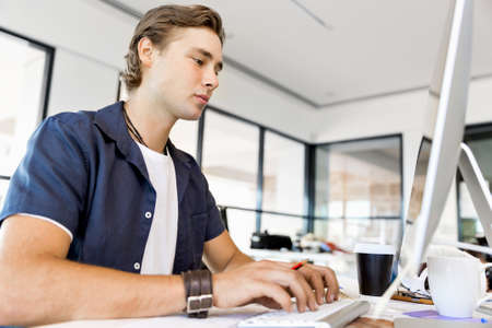 Handsome businessman working at computer