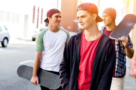 Teenage friends walking at the streetの写真素材