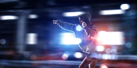 Young attractive girl boxer with bandages on hands. Mixed mediaの写真素材