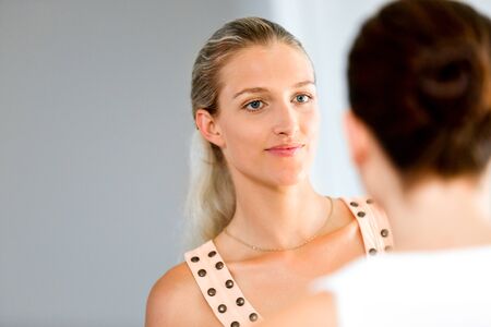 Young woman with her friend indoorsの写真素材