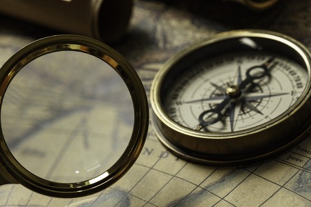 Concept of travel and discovery with old map and compass on it