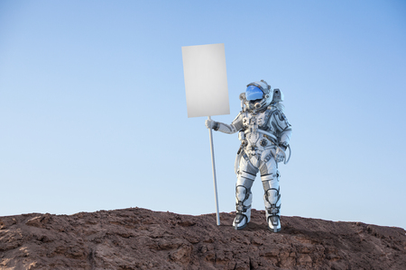 Astronaut holding blank banner for advertise. Mixed mediaの写真素材