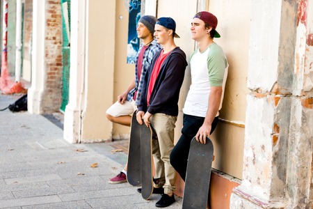 Teenage friends standing at the streetの写真素材