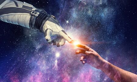 Astronauts hands in touch as symbol for creation. Mixed mediaの写真素材