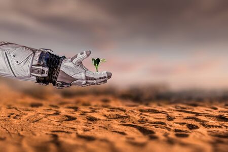 Hand of astronaut and green sprout. Mixed mediaの写真素材