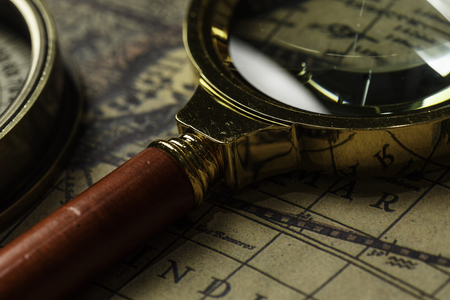 Concept of travel and discovery with old map and compass on itの写真素材