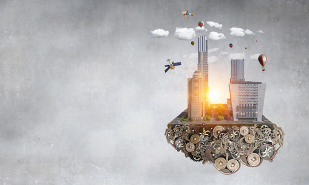 Cityscape island on gear mechanism floating in air. Mixed mediaの写真素材