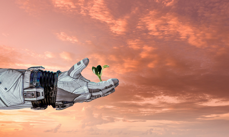 Hand of astronaut and green sprout. Mixed mediaの写真素材