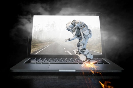 Astronaut coming out of laptop screen. Mixed mediaの写真素材