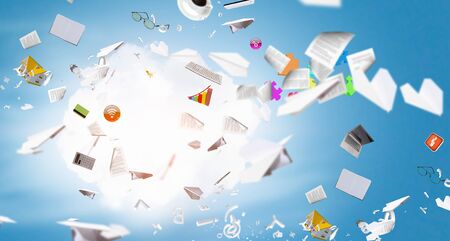 Background image with business items and papers flying in airの写真素材