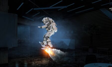Astronaut explorer in dark interior ride spaceboard. Mixed mediaの写真素材