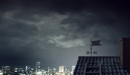 Bright lightning striking roof of house. Mixed mediaの写真素材