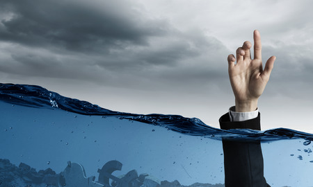 Hand of person drowning in waterの写真素材