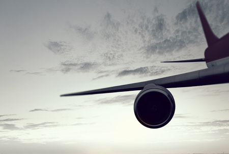 Wing of an airplane in cloudy sky. Mixed mediaの写真素材