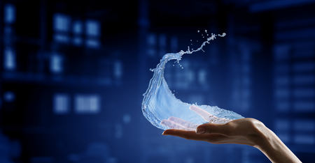 Close of person hands holding water splashesの写真素材