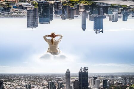 Woman float above cityの写真素材