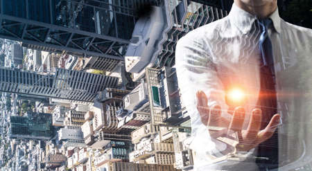 Businessman showing palm. Mixed mediaの写真素材