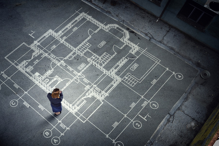 Top view of builder woman and construction drawings on floor. Mixed mediaの写真素材