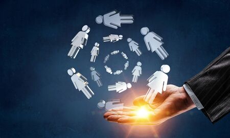 Hand of man and glass figure icons in palmの写真素材