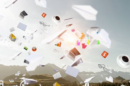 Background image with business items and papers flying in air