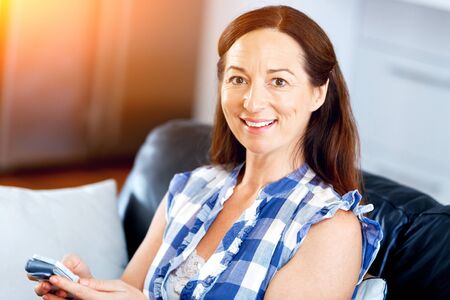 Portrait of woman holding phone