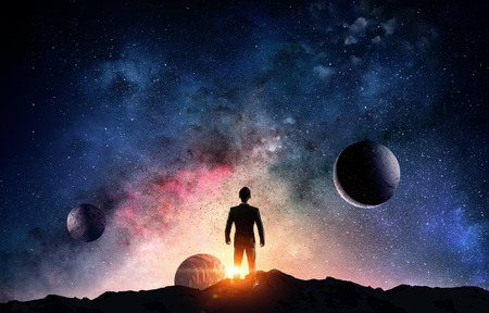 Back view of businessman on fantasy space background. Mixed mediaの写真素材