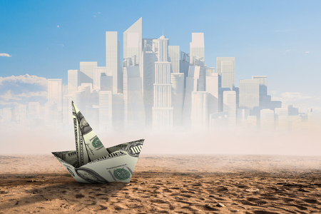Dollar banknote ship in desert as symbol for financial crisis . Mixed mediaの写真素材