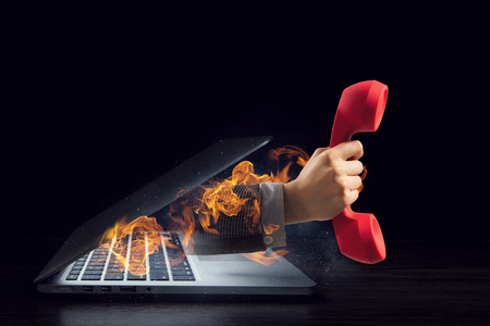 Hand comes from notebook screen. Mixed mediaの写真素材