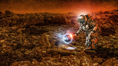 Spaceman on planet surface and green growing sprout. Elements of this image are furnished by NASAの写真素材