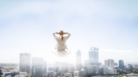 Woman float above cityの写真素材