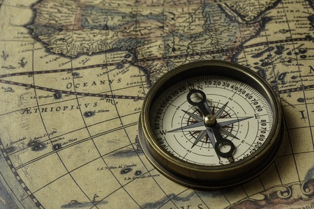 Concept of travel and discovery with old map and compass on itの写真素材