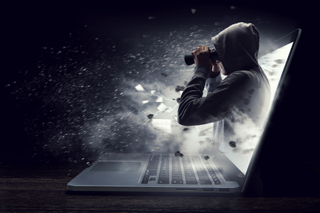 Concept of Internet security with hacker and laptop. Mixed mediaの写真素材