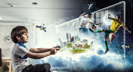 Boy playing a video game. Mixed mediaの写真素材