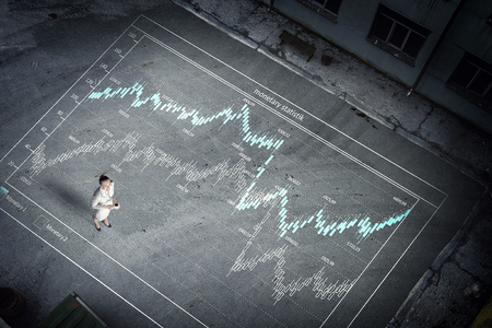 Top view of businesswoman and business statistics on floorの写真素材