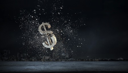 Cracked stone dollar sign on dark background. Mixed media