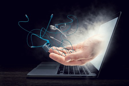 Internet connection plug and human hands from laptop screen. Mixed mediaの写真素材