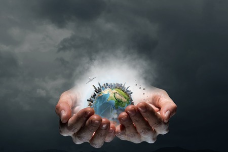 Businessman hands holding Earth planet.