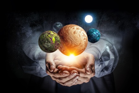 Close of businessman and system of planets in his palms. Mixed media