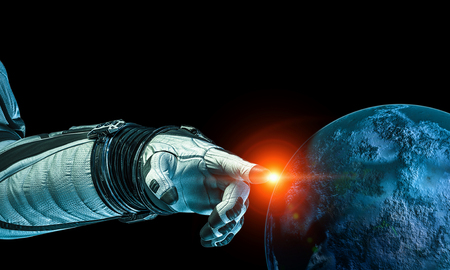 Close of astronaut robotic hand touching planet