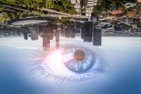 Bird eye view of modern city with human female eyeの写真素材