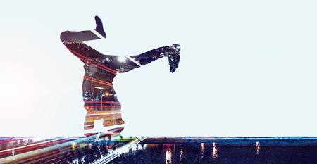 Double exposure of dancer silhouette and modern city on white backgroundの写真素材
