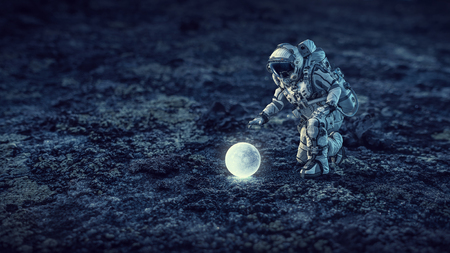 Spaceman in suit reaching hand to touch something. Mixed mediaの写真素材