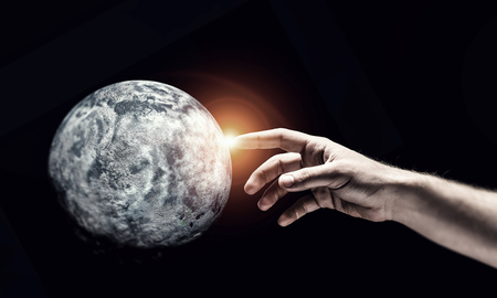 Close of hand touching with finger planetの写真素材