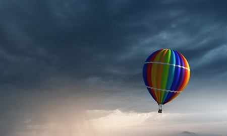 Color aerostat floating in dark sky. Mixed mediaの写真素材
